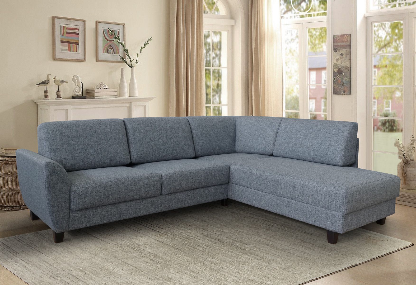 Wilhelm avokulmasohva harmaana, jossa on avattava vuodemekanismi. Kuvattuna olohuoneessa.